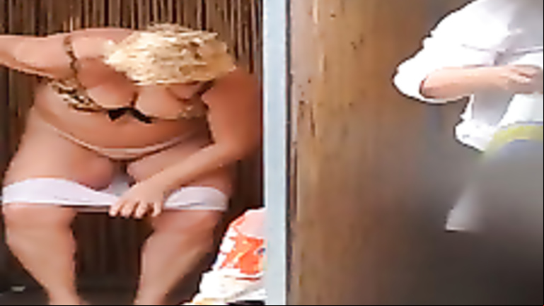 Fat mature lady changing at the beach