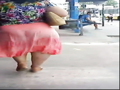 Latina woman with a very large booty walks around the town
