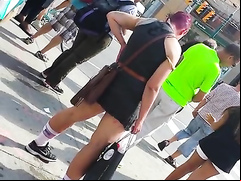 Punk girl pisses hard on the middle of the sidewalk